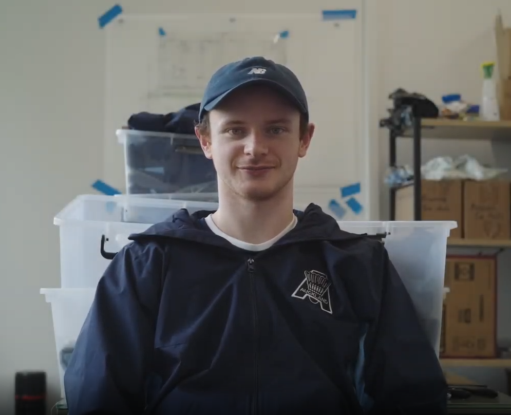 Portrait of Adam Jeffrey wearing his Auckland Badminton jacket